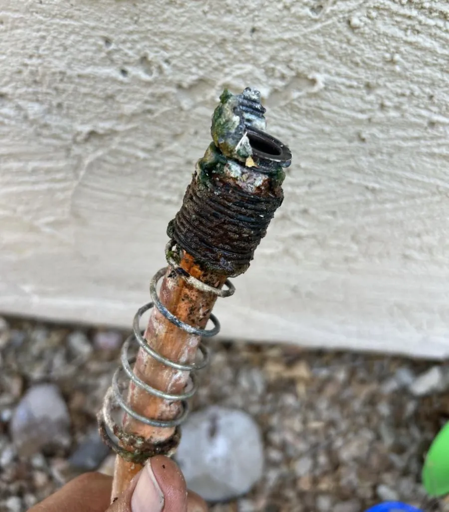A removed hose bib showing severe corrosion and mineral buildup from Arizona hard water